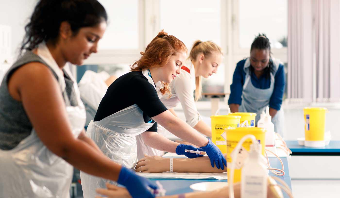 Medical students practising taking blood