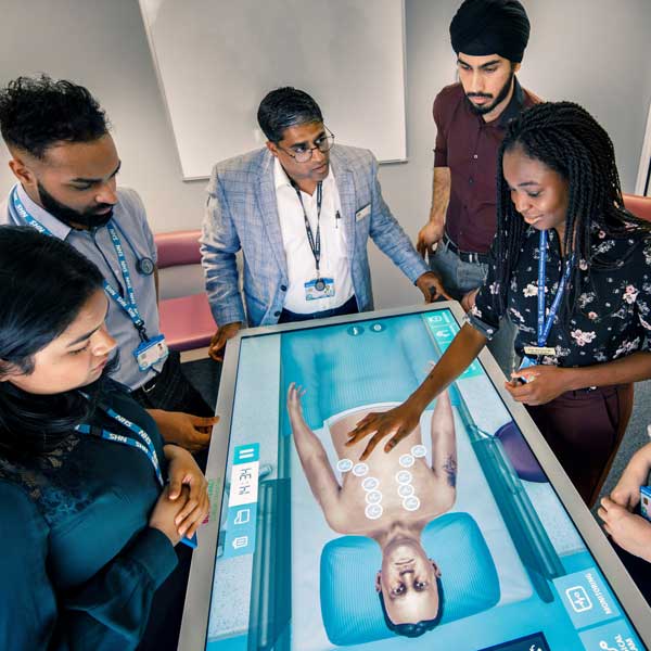 Students examining a digital patient case study with a clinician