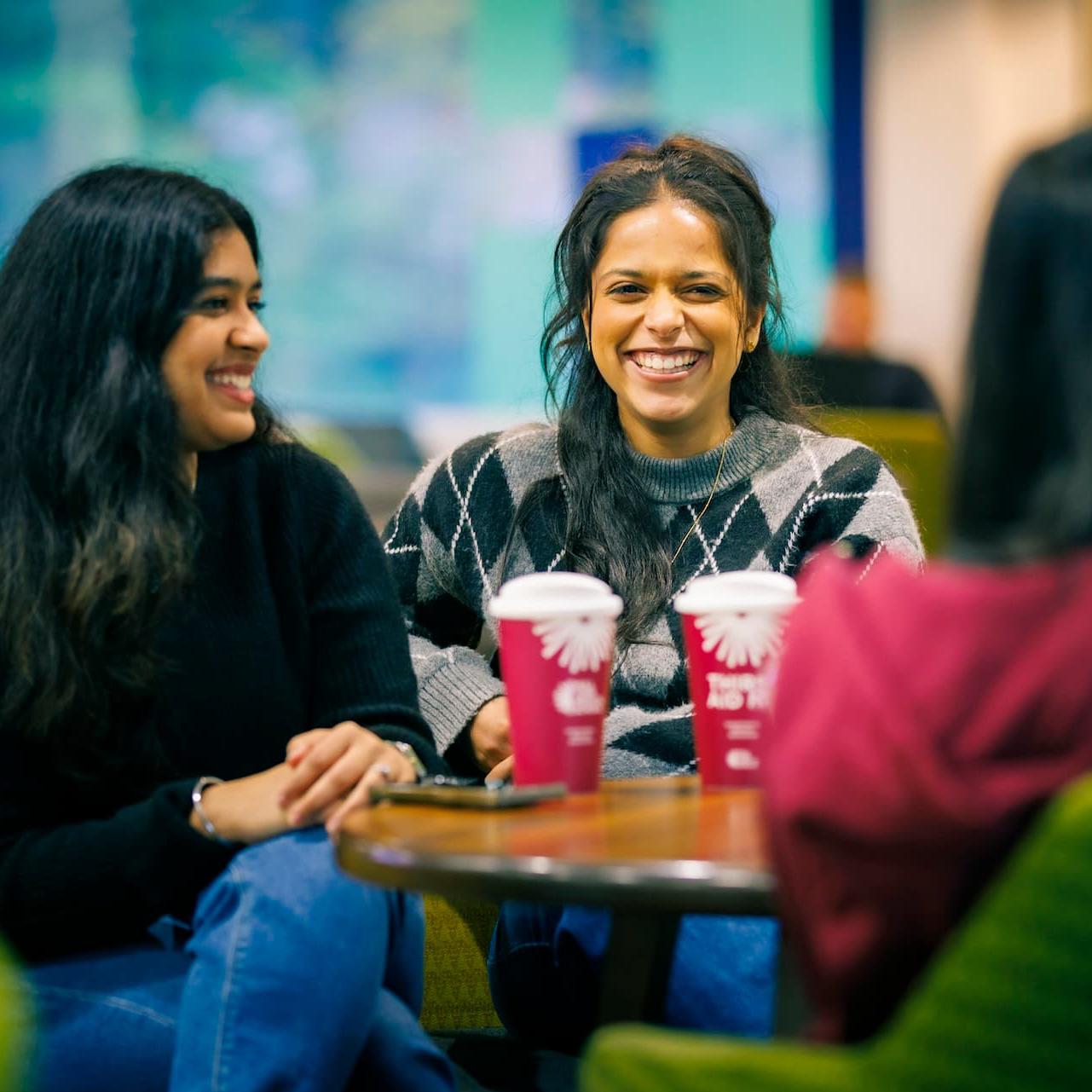Students chatting over coffee on the Hull campus