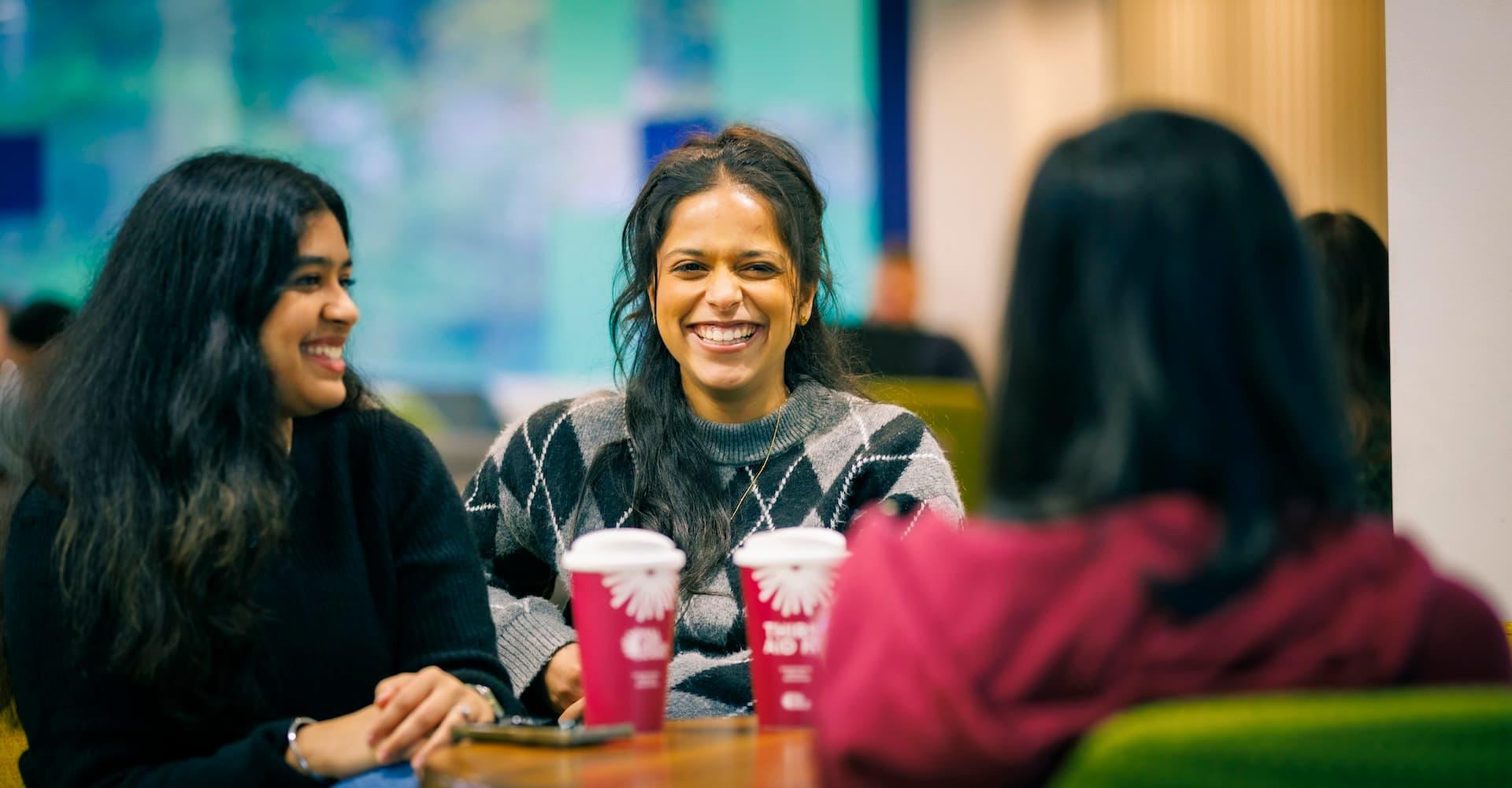 Students chatting over coffee on the Hull campus
