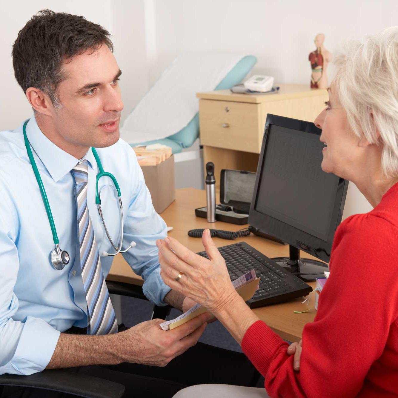 GP talking to a senior woman in the surgery