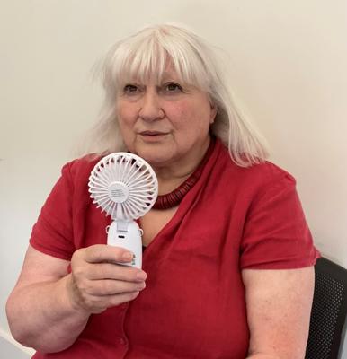 Service user holding a hand fan