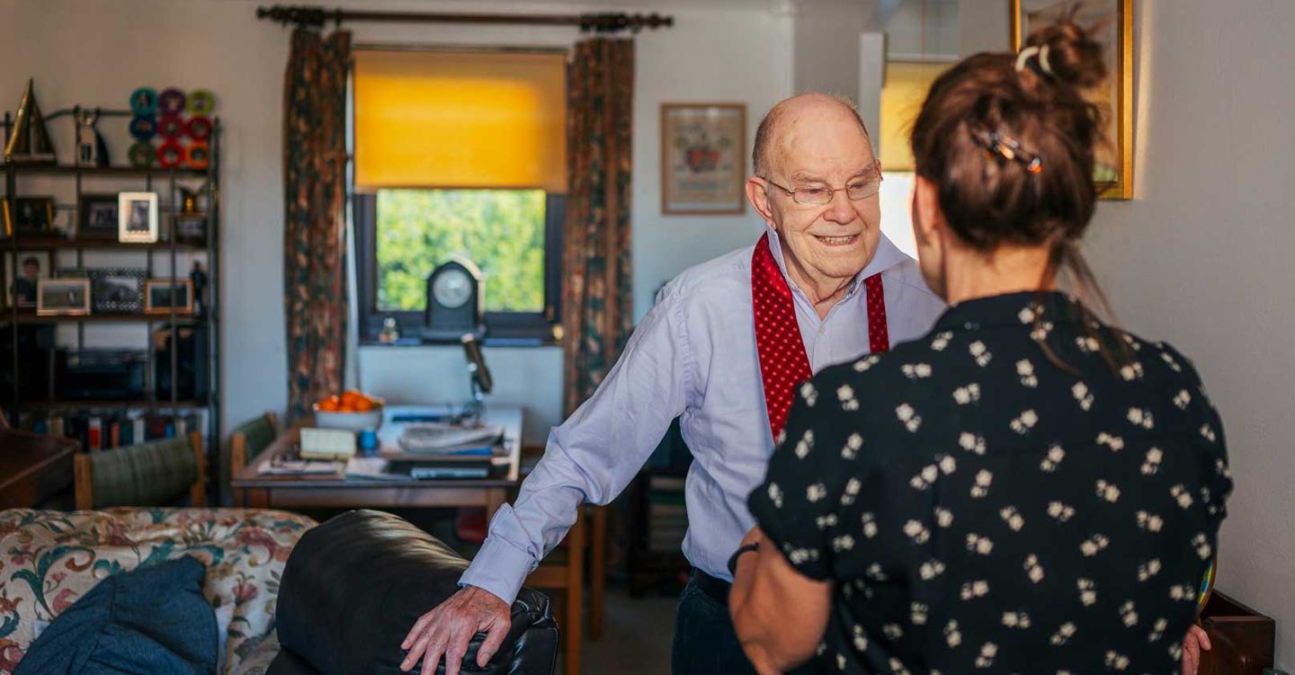 Older man with carer at home