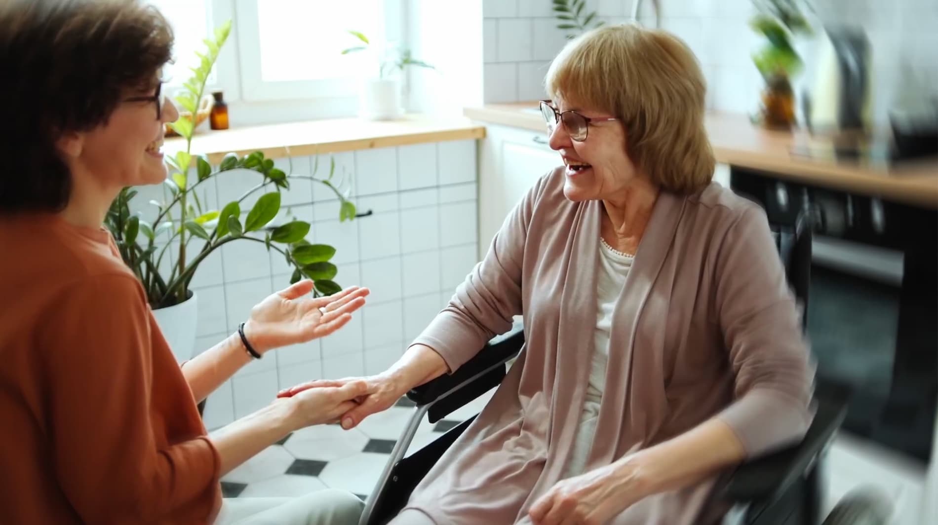 Two women in conversation, one is a wheelchair user
