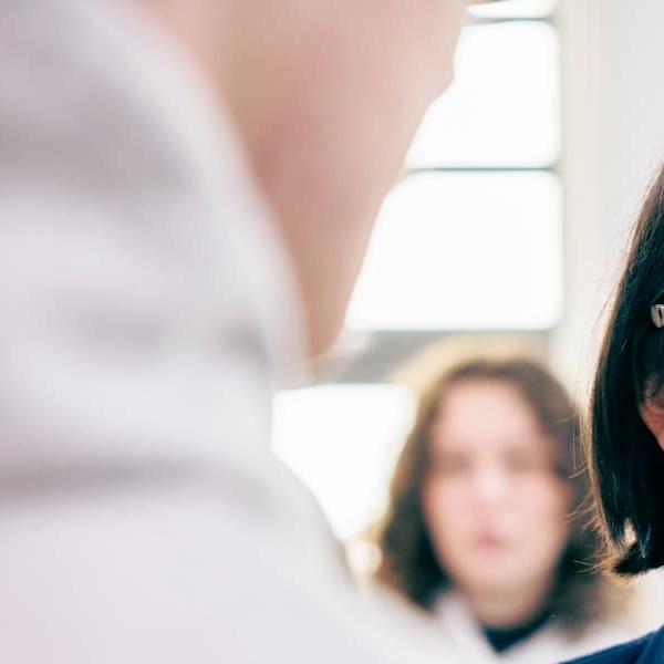 A member of Hull York Medical School staff chatting to students during an anatomy session