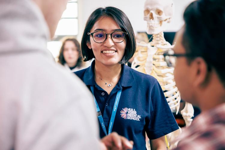 A member of Hull York Medical School staff chatting to students during an anatomy session